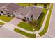 Aerial view of a well-manicured lawn, brick driveway, and three-car garage highlighting curb appeal at 1518 Alligator St, St Cloud, FL 34771