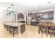 Open kitchen features stainless appliances, center island with stools, and adjacent dining area at 1518 Alligator St, St Cloud, FL 34771