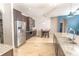 Kitchen with stainless appliances, large island with seating, granite counters, and tile floors at 1518 Alligator St, St Cloud, FL 34771