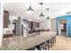 Spacious kitchen featuring a large island with bar seating, stainless appliances, and modern pendant lights at 1518 Alligator St, St Cloud, FL 34771
