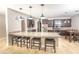 Open kitchen with large island, modern lighting, stainless steel appliances, and granite countertops at 1518 Alligator St, St Cloud, FL 34771