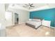Primary bedroom with tray ceiling, neutral tones, and ensuite bathroom entrance at 1518 Alligator St, St Cloud, FL 34771