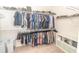 Spacious walk-in closet features ample hanging storage on multiple levels and a neutral color palette at 1518 Alligator St, St Cloud, FL 34771