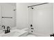 Bright bathroom featuring subway tile walls, a modern toilet, and a tub/shower combo with black fixtures at 2171 E South St # 5, Orlando, FL 32803