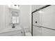 Modern bathroom featuring a glass-enclosed shower, white subway tile, and black fixtures at 2171 E South St # 5, Orlando, FL 32803