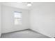 Bright bedroom featuring neutral carpet, ceiling fan, and a single window at 2171 E South St # 5, Orlando, FL 32803