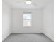Bright bedroom featuring neutral carpet, ceiling fan, and a single window at 2171 E South St # 5, Orlando, FL 32803