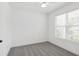 Clean and bright bedroom featuring neutral carpet, ceiling fan and a large sunny window at 2171 E South St # 5, Orlando, FL 32803