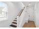 Clean entryway featuring wood floors, staircase, and white walls for a modern feel at 2171 E South St # 5, Orlando, FL 32803