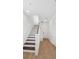 Bright entryway featuring wood floors, staircase, and white walls creating a clean aesthetic at 2171 E South St # 5, Orlando, FL 32803