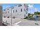 Newer townhouse showcasing the garage, the facade, landscaping, and sidewalk at 2171 E South St # 5, Orlando, FL 32803