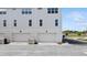 Exterior facade of the townhome, showcasing the garage, landscaping, and sidewalk at 2171 E South St # 5, Orlando, FL 32803