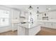 Spacious kitchen with large center island, white cabinets, gray countertops, and hardwood floors at 2171 E South St # 5, Orlando, FL 32803