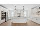A bright, modern kitchen with a large island, stainless steel appliances, and hardwood flooring at 2171 E South St # 5, Orlando, FL 32803