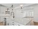 Spacious kitchen with large center island, farmhouse sink, white cabinets, and hardwood floors at 2171 E South St # 5, Orlando, FL 32803