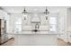 Island with white cabinets, gray countertops, pendant lighting, and stainless steel appliances at 2171 E South St # 5, Orlando, FL 32803