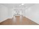 Bright living room featuring hardwood floors, neutral walls, and open floor plan to the kitchen at 2171 E South St # 5, Orlando, FL 32803