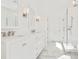 Modern bathroom featuring double sinks, marble floors, sconces, and walk in shower at 259 Severn Way # 38, Orlando, FL 32803
