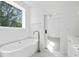 A luxury bathroom with a soaking tub, window view, and modern fixtures create a spa-like experience at 259 Severn Way # 38, Orlando, FL 32803
