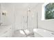 A bright bathroom features a glass-enclosed shower, a soaking tub, and a modern vanity at 259 Severn Way # 38, Orlando, FL 32803