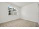 Bright bedroom featuring neutral carpet, a window, and white walls and trim at 259 Severn Way # 38, Orlando, FL 32803