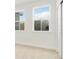 Bright bedroom featuring neutral carpet, multiple windows, and white walls and trim at 259 Severn Way # 38, Orlando, FL 32803