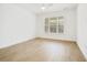 Spacious bedroom with wood-look tile flooring, ceiling fan, and a large window for plenty of natural light at 259 Severn Way # 38, Orlando, FL 32803