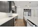 This kitchen features gray cabinets, stainless steel appliances, white countertops, and modern lighting at 259 Severn Way # 38, Orlando, FL 32803