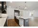 A bright kitchen features a large island with a white countertop, gray cabinets and stainless steel appliances at 259 Severn Way # 38, Orlando, FL 32803