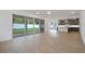 Large living room with tile floors, a sliding glass door to the patio, and a view of the kitchen at 259 Severn Way # 38, Orlando, FL 32803