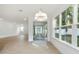Bright living room with a modern chandelier, tile floors and large windows with natural light at 259 Severn Way # 38, Orlando, FL 32803