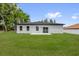Well-maintained backyard with a sliding glass door and lush green grass, ideal for relaxation at 494 Marion Oaks Trl, Ocala, FL 34473
