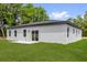 Home featuring a sliding glass door leading to a spacious backyard with a white fence at 494 Marion Oaks Trl, Ocala, FL 34473