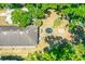 Aerial view of property showcasing backyard, roof, mature trees, and proximity to neighboring homes at 535 Madison Ave, Daytona Beach, FL 32114