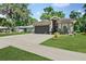 Charming gray single-story home featuring an attached two-car garage, beautiful lawn, and well-manicured landscaping at 535 Madison Ave, Daytona Beach, FL 32114