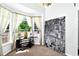 Bright living room featuring a bay window, comfortable seating, and a modern accent wall at 535 Madison Ave, Daytona Beach, FL 32114