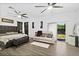 Spacious main bedroom featuring modern ceiling fans, hardwood floors, sitting area, and sliding glass door at 535 Madison Ave, Daytona Beach, FL 32114