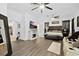 Spacious main bedroom featuring modern ceiling fans, hardwood floors, sitting area, and fireplace at 535 Madison Ave, Daytona Beach, FL 32114