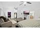 Spacious main bedroom featuring modern ceiling fans, hardwood floors, fireplace, and sitting area at 535 Madison Ave, Daytona Beach, FL 32114