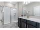 Bathroom featuring a walk-in shower with glass doors, modern vanity, and neutral colors at 11357 Satire St, Orlando, FL 32832