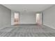 Large bedroom with neutral carpet, two doors, and plenty of natural light at 11357 Satire St, Orlando, FL 32832