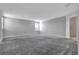 Spacious carpeted room featuring a large window and entryways to other parts of the home at 11357 Satire St, Orlando, FL 32832