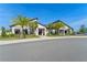 Exterior of community clubhouse featuring modern design, lush landscaping, and ample parking at 11357 Satire St, Orlando, FL 32832