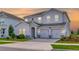 Charming two-story home with a two-car garage, neutral paint, and manicured landscaping at 11357 Satire St, Orlando, FL 32832