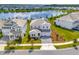 Two-story white home with a gray driveway, well-kept landscaping, and a view of the lake at 11357 Satire St, Orlando, FL 32832