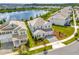 Two-story white home with a gray driveway, well-kept landscaping, and a view of the lake at 11357 Satire St, Orlando, FL 32832