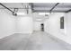 Spacious, clean three-car garage with white walls and ample lighting at 11357 Satire St, Orlando, FL 32832