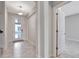 Hallway featuring tile flooring, a decorative light fixture and a frosted glass entry door at 11357 Satire St, Orlando, FL 32832