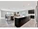 Kitchen island open to the dining and living areas featuring modern cabinets, countertops and stainless appliances at 11357 Satire St, Orlando, FL 32832