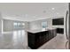 Modern kitchen featuring dark cabinetry, quartz countertops, and stainless steel appliances at 11357 Satire St, Orlando, FL 32832